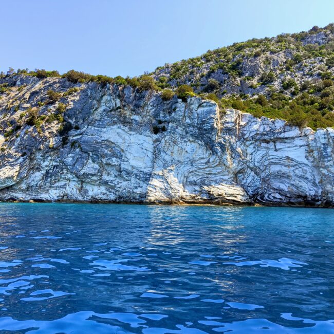 Majestic white limestone cliffs and crystal blue sea during a coastal cruise